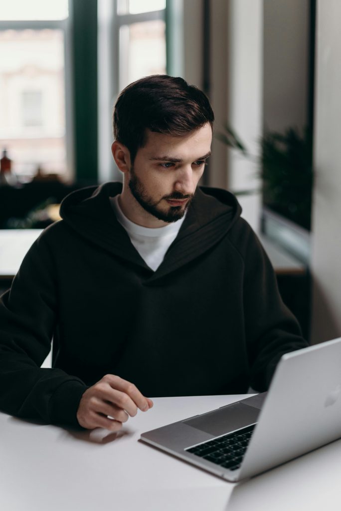 Image of man looking at  Laptop